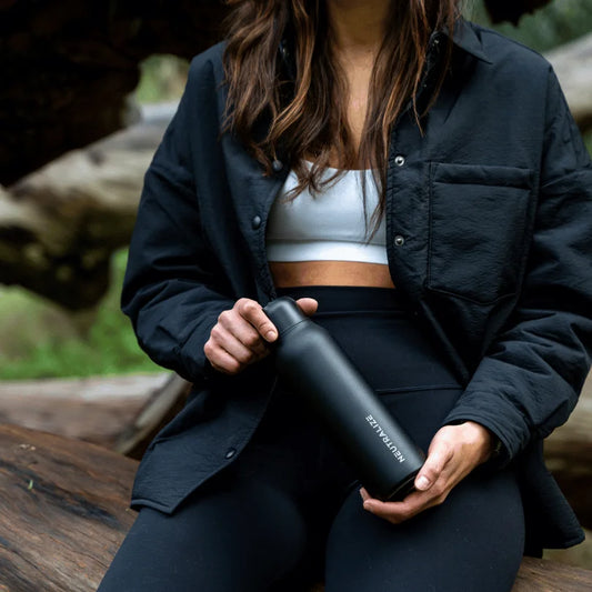 Girl holding a black bottle