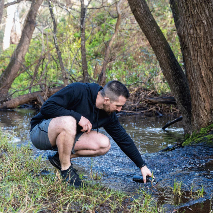 A man pours water into a bottle